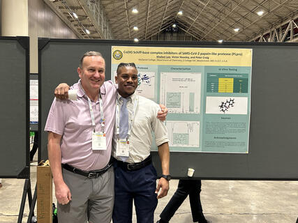Peter Craig and Khaleel Lee pose for a photo with their presented research