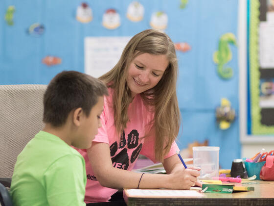 Student teaching one-on-one in elementary school setting.