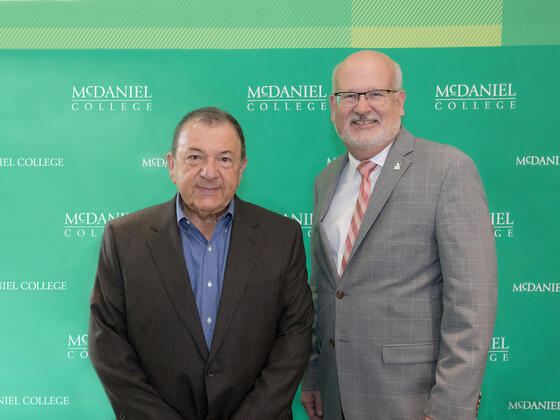 Martin K.P. Hill, current trustee and former board chair, with McDaniel President Roger N. Casey
