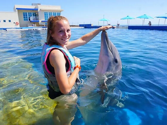 McDaniel College alumna Ashley Pritchard '16 with dolphin 