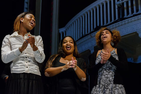 Three women singing in the McDaniel College Gospel Choir.