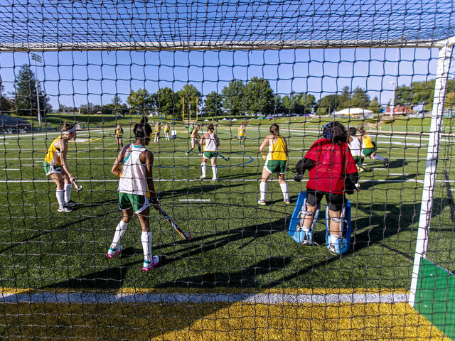 Field Hockey players in action on the field.