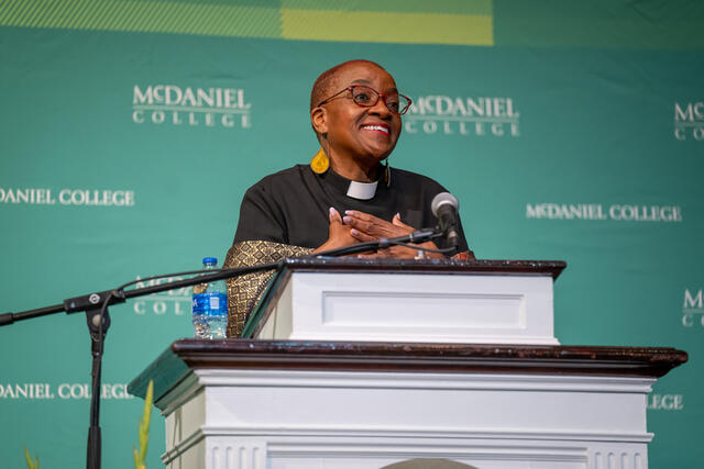 Rev. Nontombi Naomi Tutu speaking at a podium at McDaniel's Black History Month Convocation.
