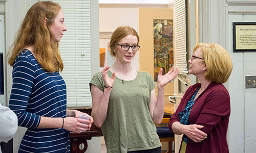 Juniors Carrie Kaufmann, a Psychology major from Hanover, Pa., and Tori Simmons, a Political Science and Art History major from Bowie, Md., talk 1880âs art with Robyn Allers, McDaniel president Roger Caseyâs wife, during the Art in Paris Reacting to the Past game