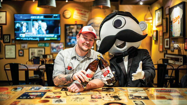 Christopher Molloy, National Bohemian brand manager, and Boh, the mascot