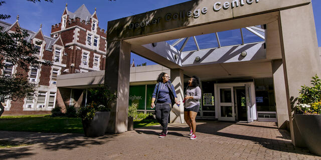 Two students walking out of Decker College Center.
