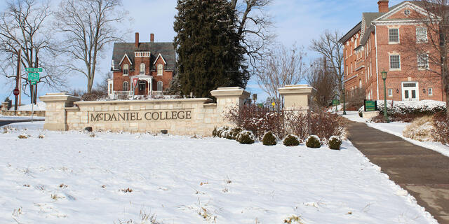 McDaniel College entrance sign in winter snow.