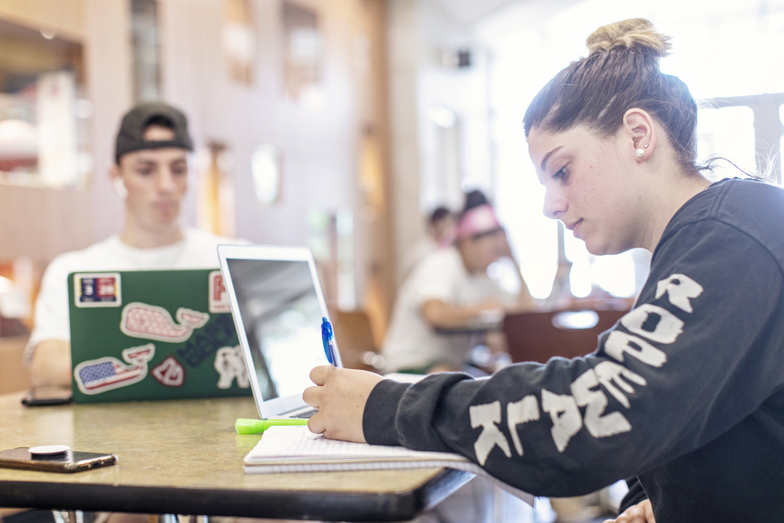 Students with notebooks and computers.