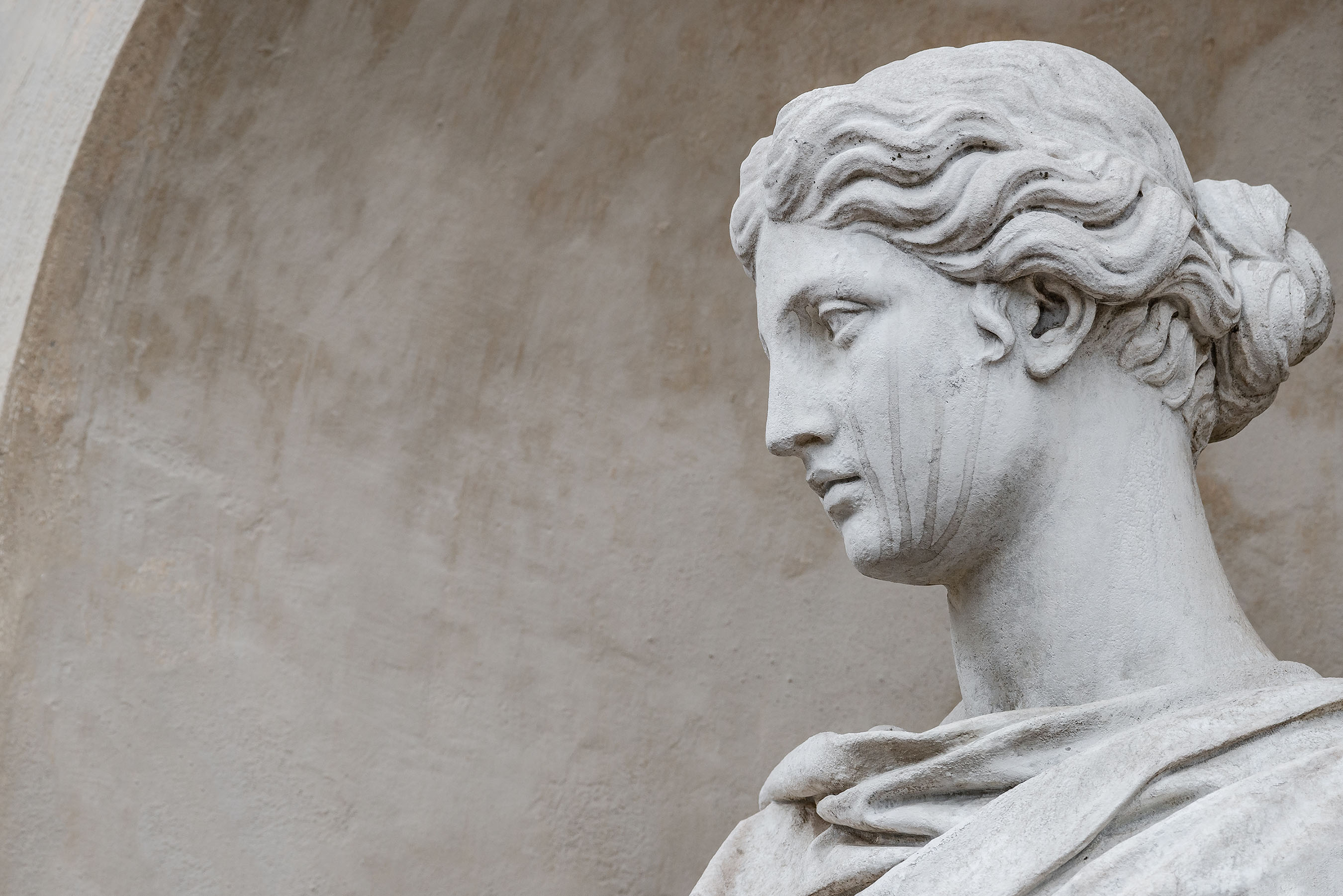 Ancient statue of sensual Italian renaissance era woman with long neck and curly hairs