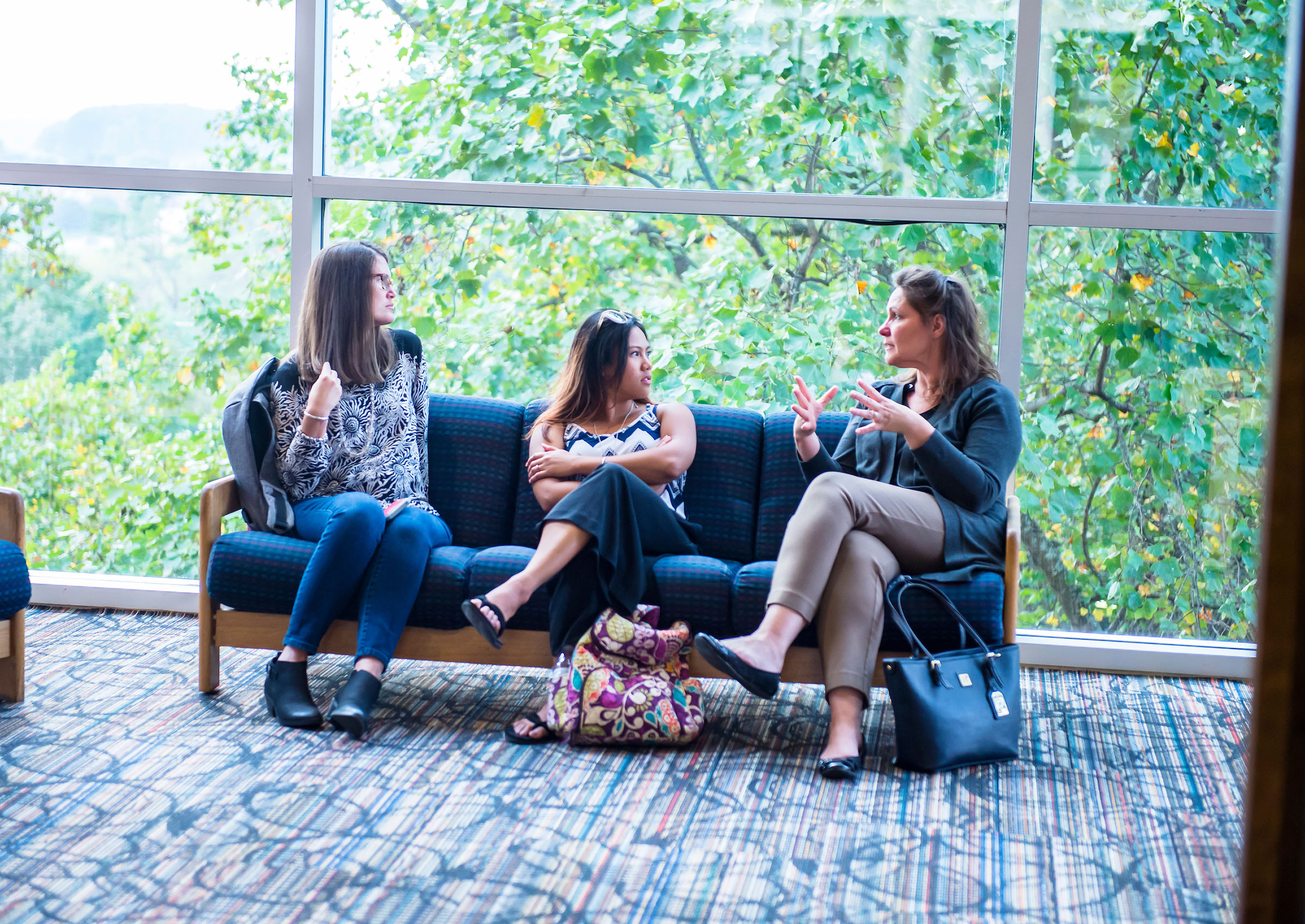 Grad students in conversation in lobby.