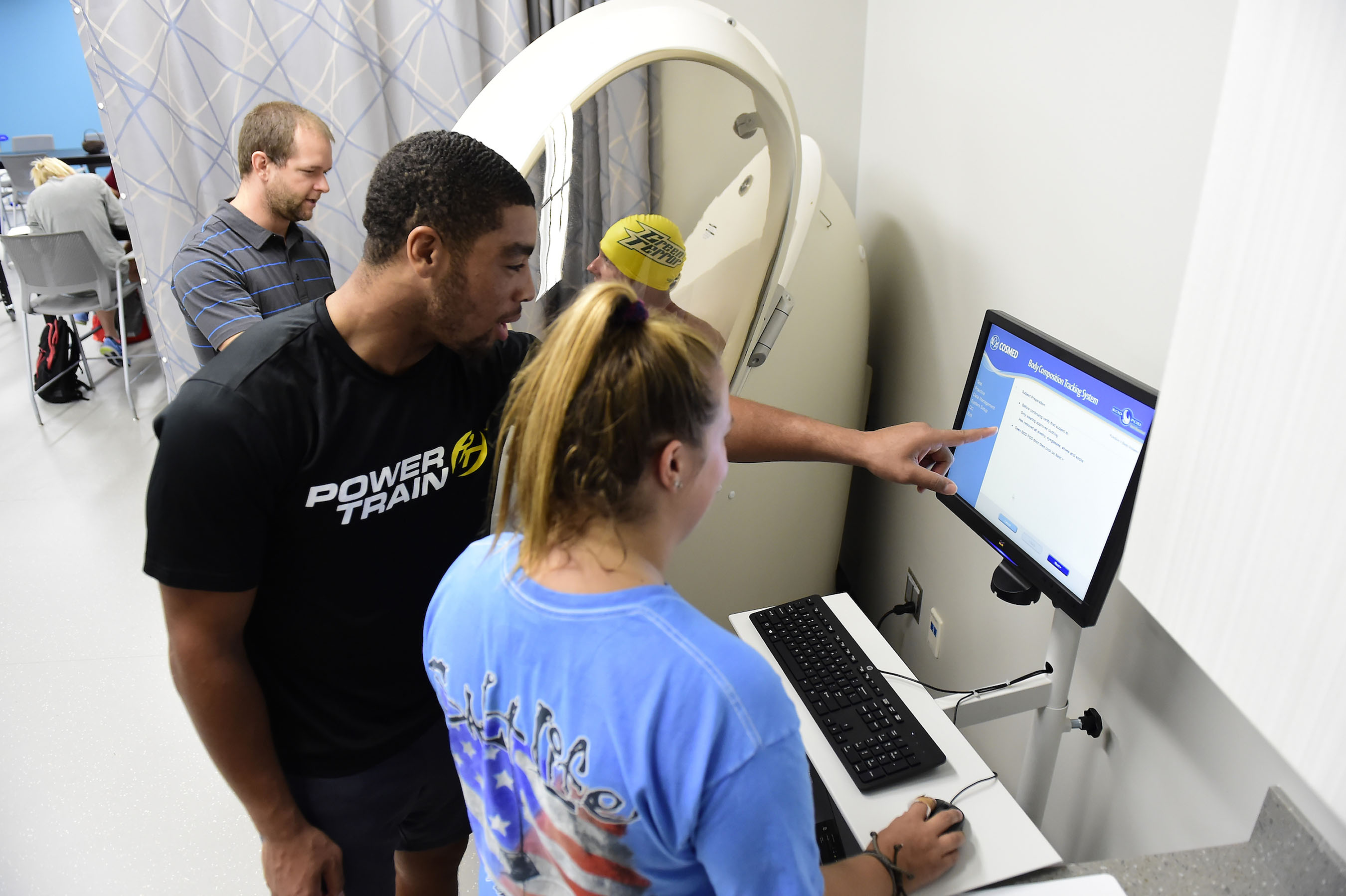 Students with professor in Kinesiology lab.