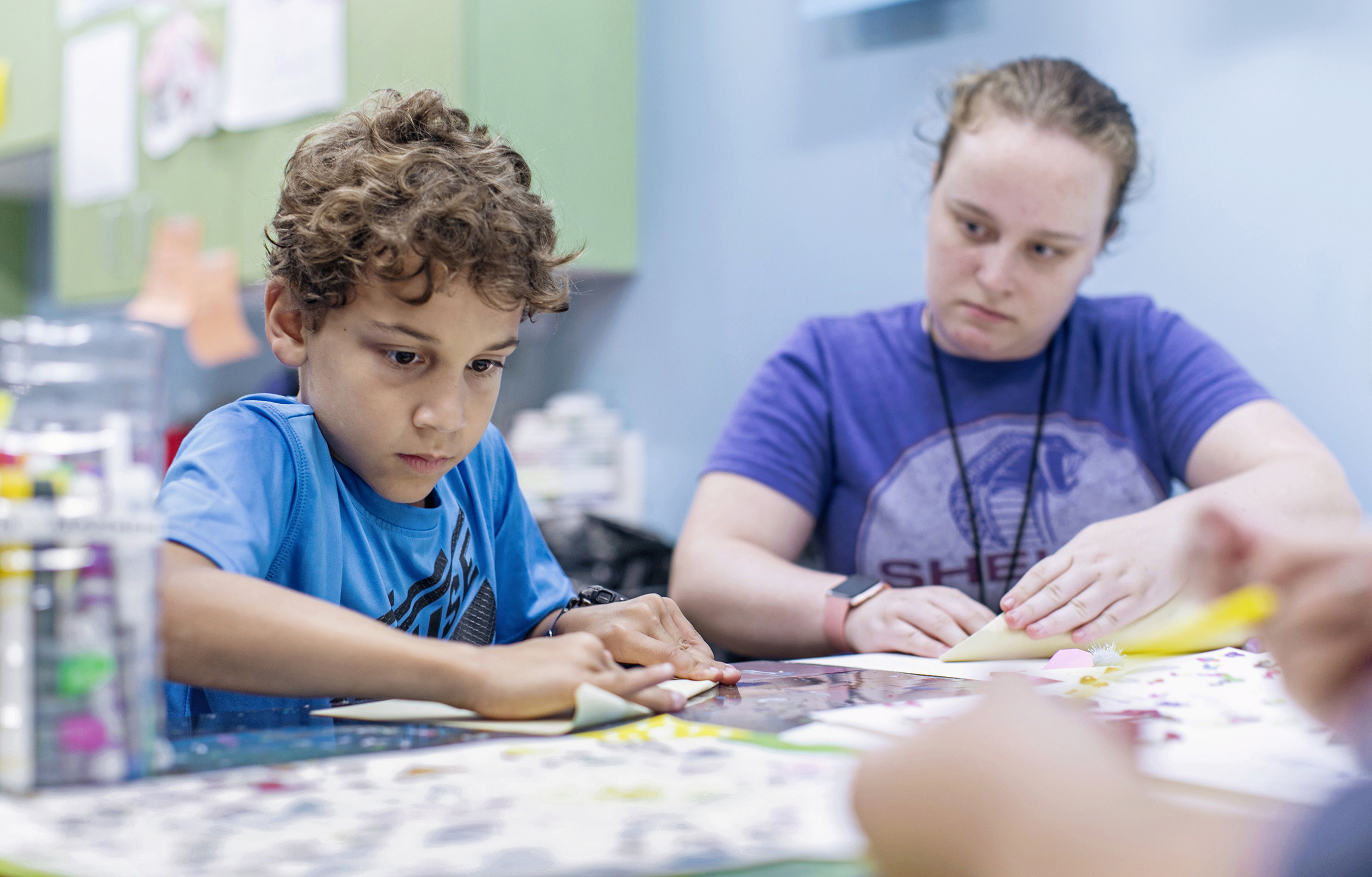 Student interacting with child at the Boys and Girls Club in Westminster.