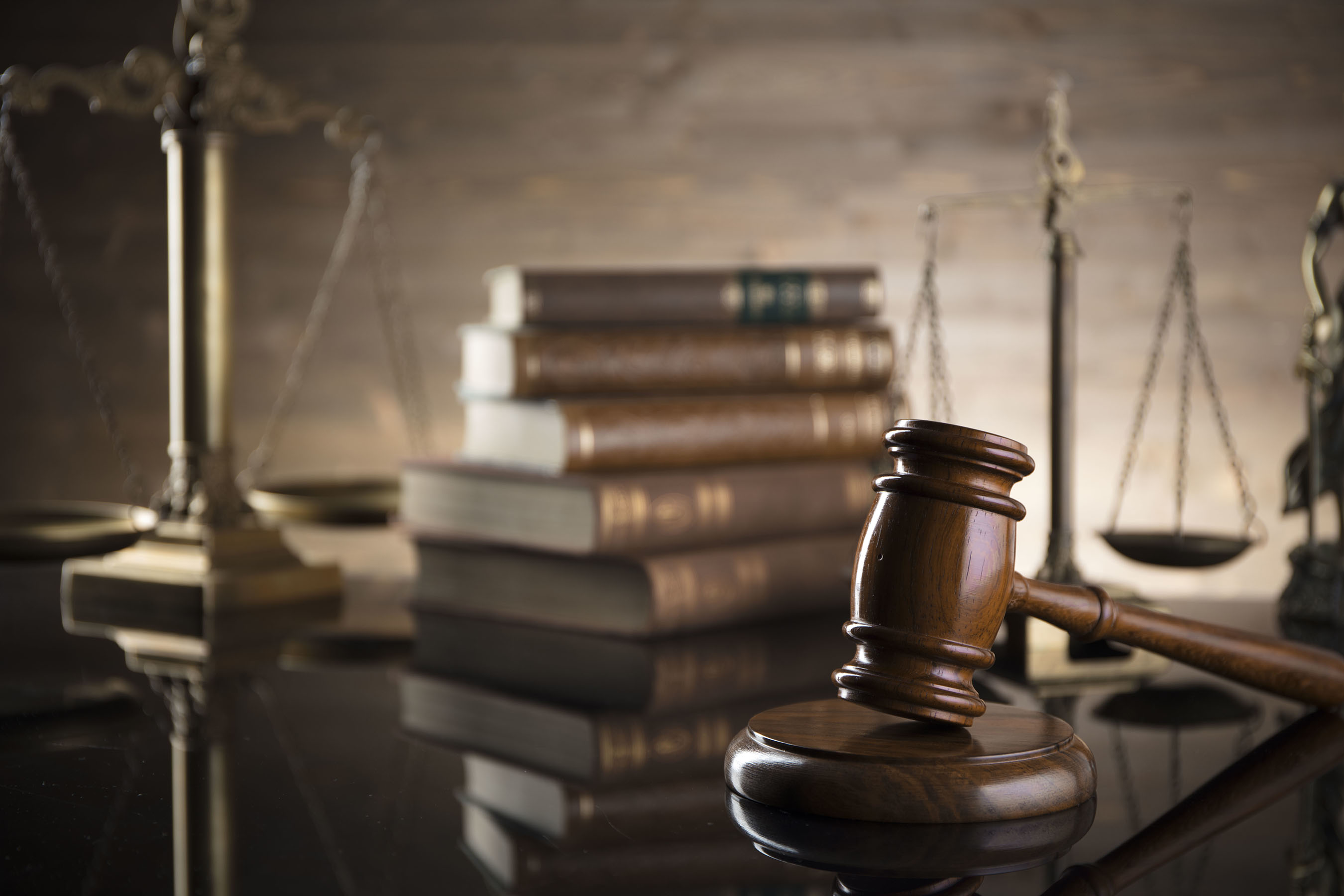 Judge gavel and scales of justice on table.