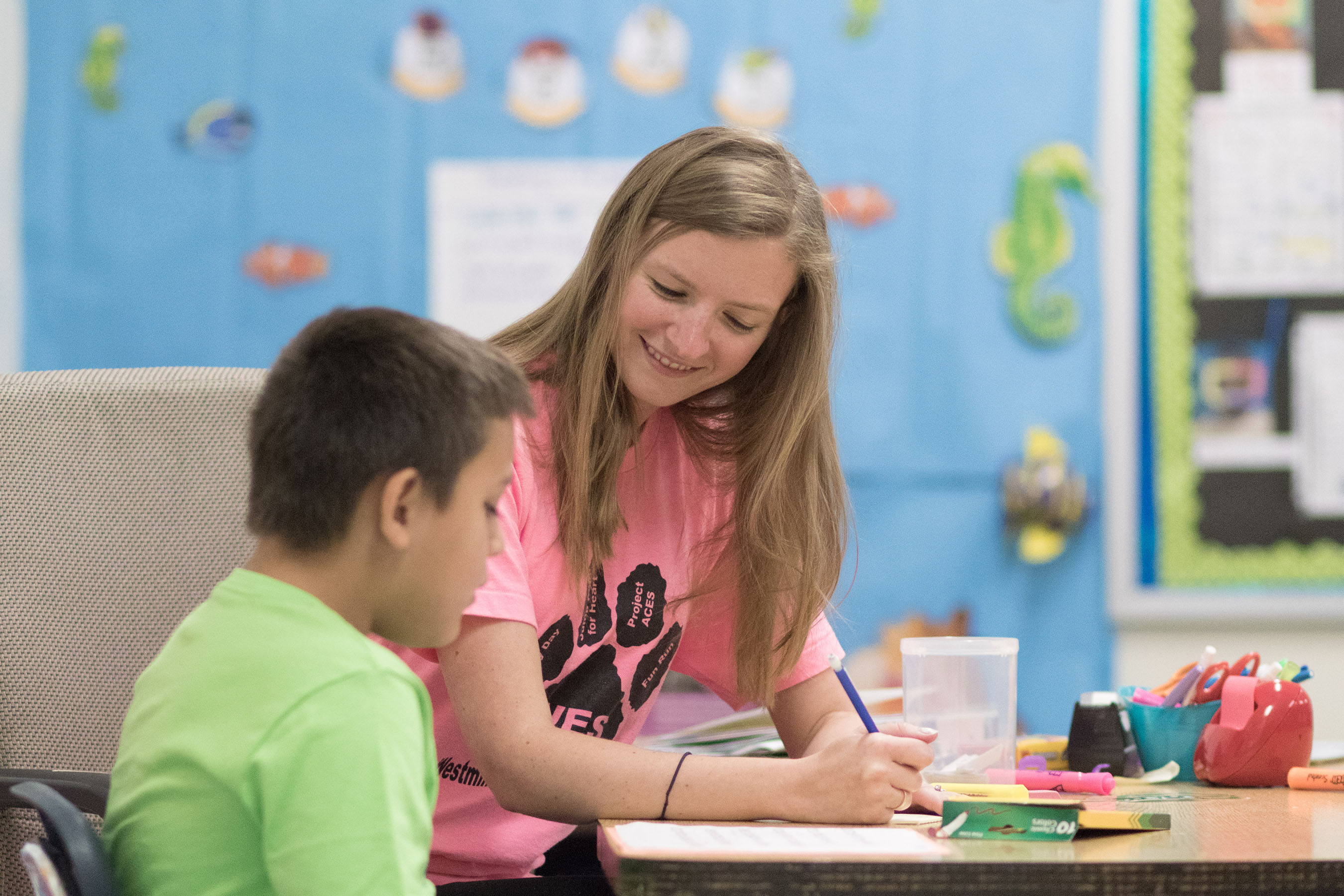 Student teaching one-on-one in elementary school setting.