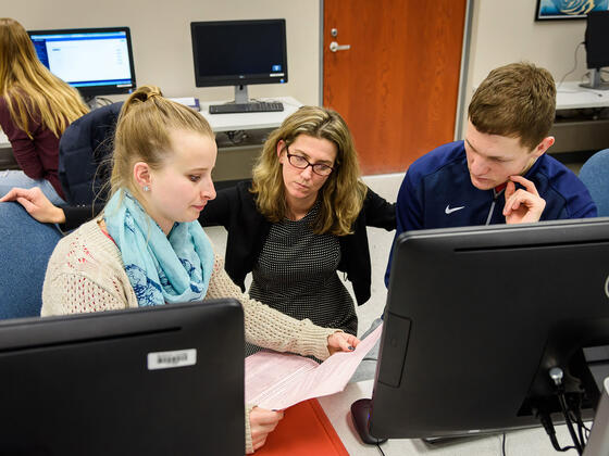 Kerry Duvall, assistant professor of accounting, assists McDaniel students during a Volunteer Income Tax Assistance (VITA) session.