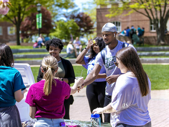 Students promoting club activities on campus.