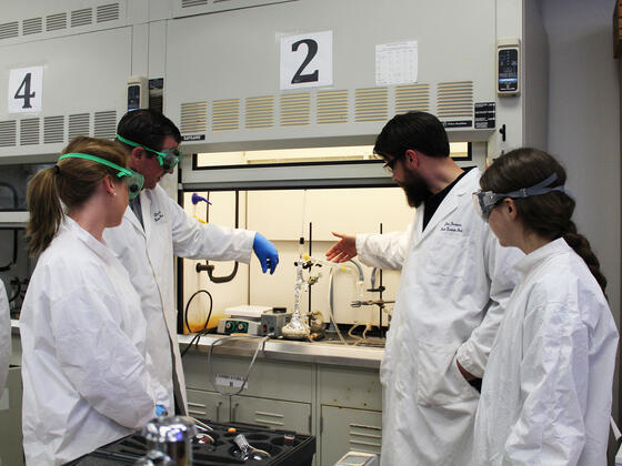 Professor and students in the chemistry lab.
