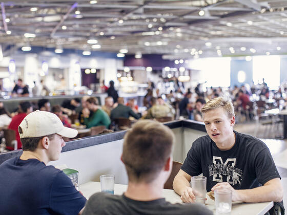 Students in conversation at table in Englar Dining Hall.