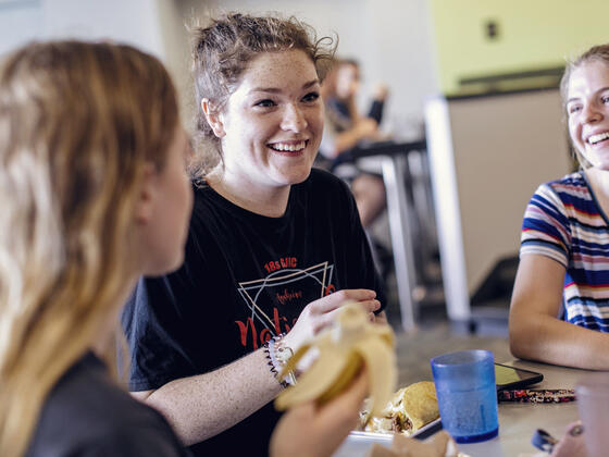 Students in conversation at table in Englar Dining Hall.