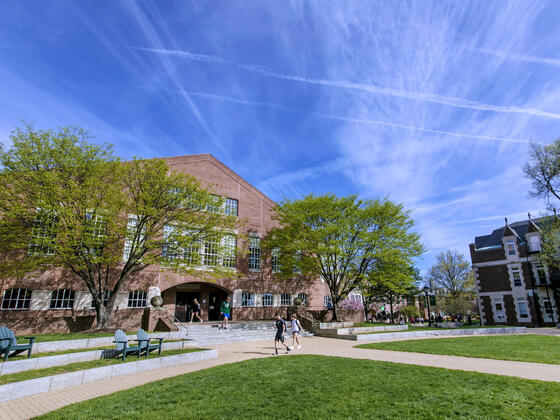 Student walking in front of Hoover Library.