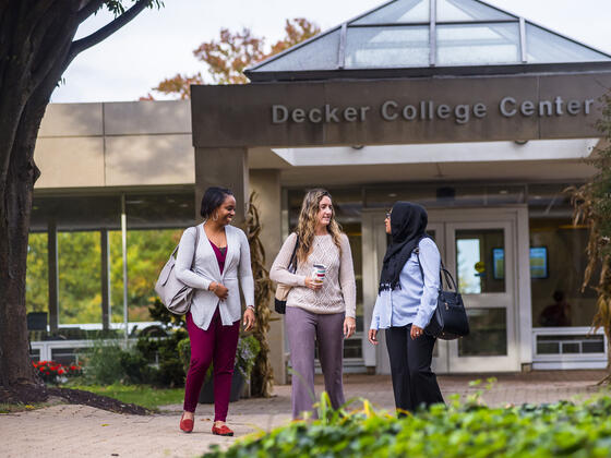 Grad students outside of Decker College Center.