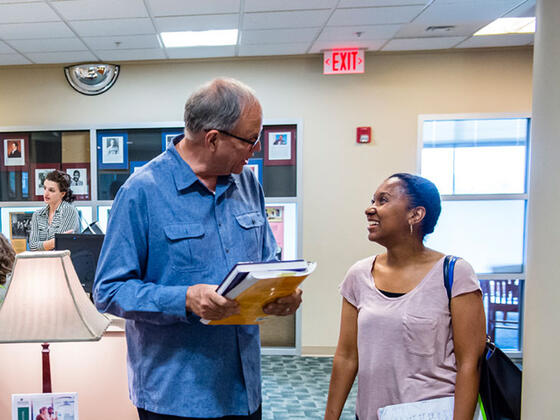 Grad professor interacting with student.