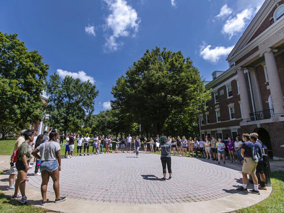 Students standing in circle on campus for McDaniel Local.