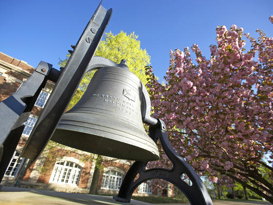 Bell in front of campus in spring