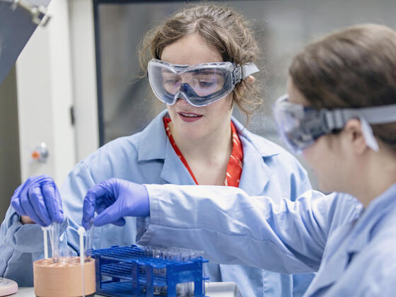 Students conducting experiment in research lab.