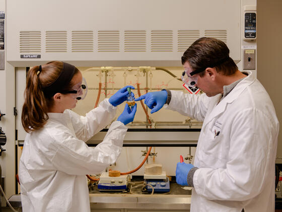 Professor with student in research lab.