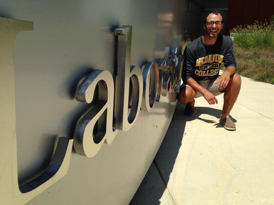 Smithsonian Intern, Jason Swartz in front of Lab sign.