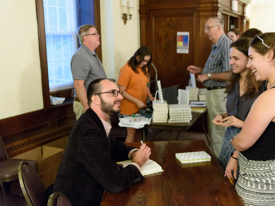 Jared Reck signs copies of his new book, “A Short History of the Girl Next Door” in McDaniel Lounge.