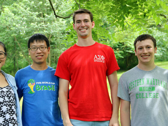  Biology professor Cheng Huang (second from left) with his research students (l-r), Molecular Biology majors Fangluo Chen, Harrison Curnutte and Garrett Gregoire.