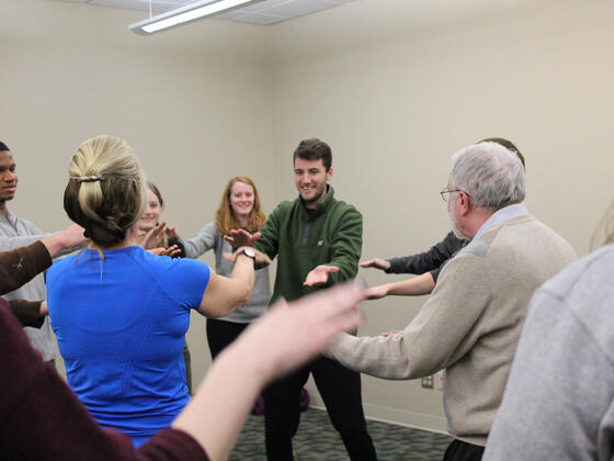 Professor Paul Mazeroff and students participating in the ancient Chinese healing art.