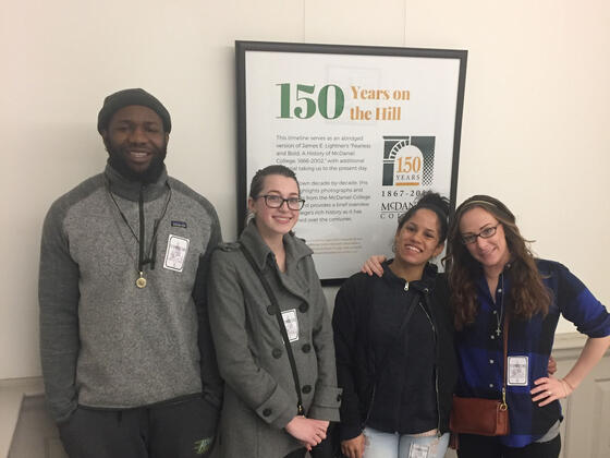 Social Work majors standing in front of poster.