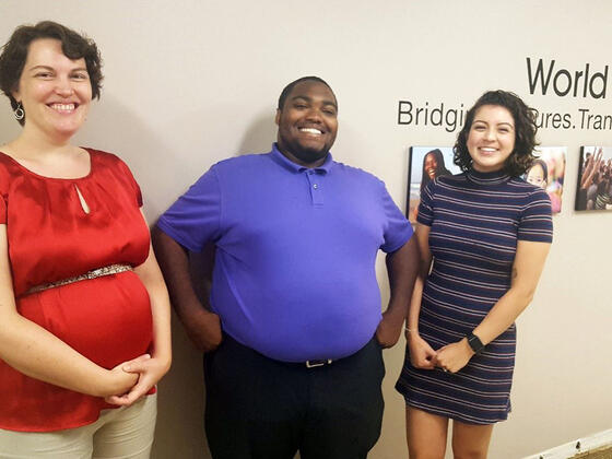 Students standing in front of World Learning entry.