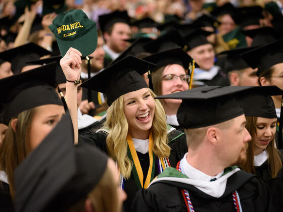 Graduates in cap and gown seated for Commencement.