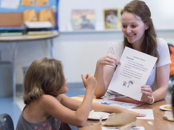 Student teaching one-on-one in elementary school setting.