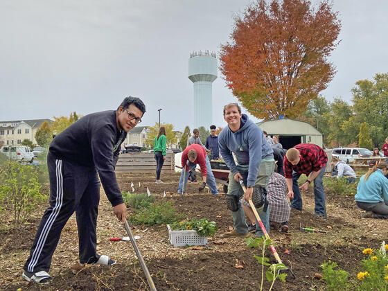 McDaniel College students Jose Osorio and Gunnar Ward till the campus garden.