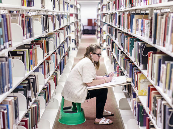 Student drawing in library