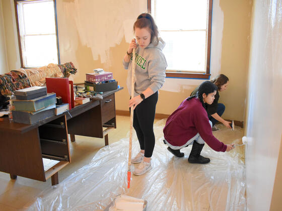 McDaniel freshmen Brooke Boyland, left, Bopha Bessire, center, and Sydney Barrett help paint the multipurpose room at Union Street United Methodist Church on Monday, Jan. 20.