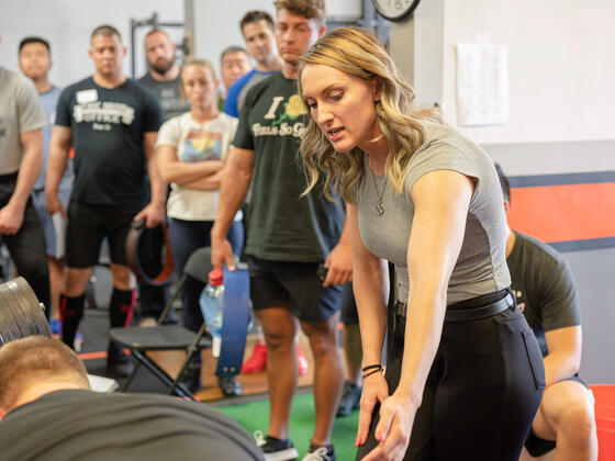Nicole Rutherford ’16 teaches the deadlift as a platform coach at the L.A. Starting Strength seminar.
