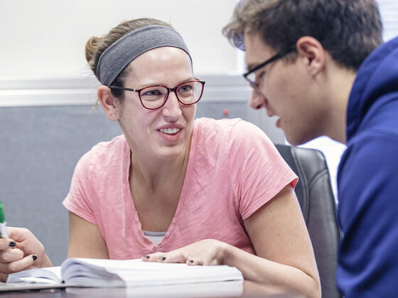 Graduate assistant with student.