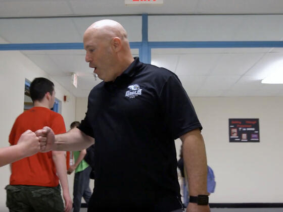 Westminster High School principal fist bumps with students