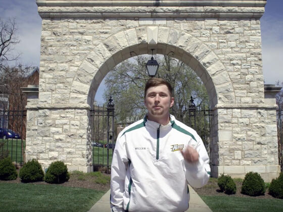 Student in front of Mcdaniel arch