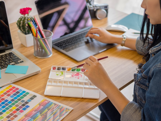 woman at desk painting