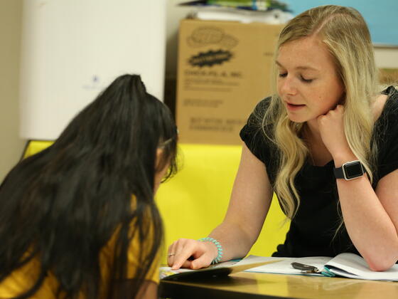 graduate student reading to a student