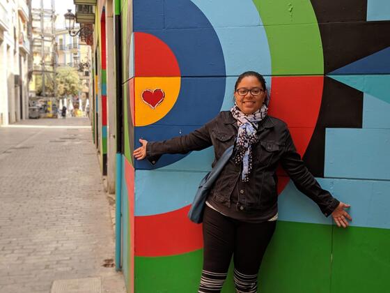 Alumni Jessica Watson in front of street art in Valencia, Spain.