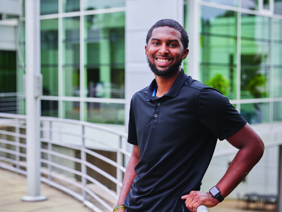 Alumni Kevin Webster posing on campus.