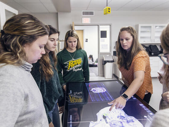 Students using a large touchscreen to view anatomy.